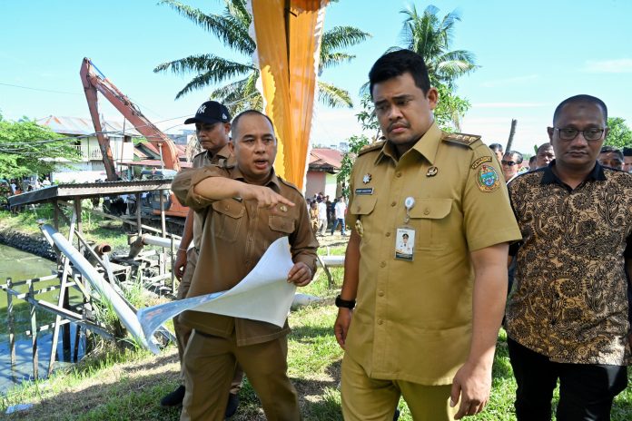 Text foto : Gubernur Sumut Bobby Nasution meninjau Proses Pengerukan Sedimen Waduk di Kelurahan Pekan, Kecamatan Tanjungpura, Kabupaten Langkat, Senin (21/7/2025). (Foto : Ist)